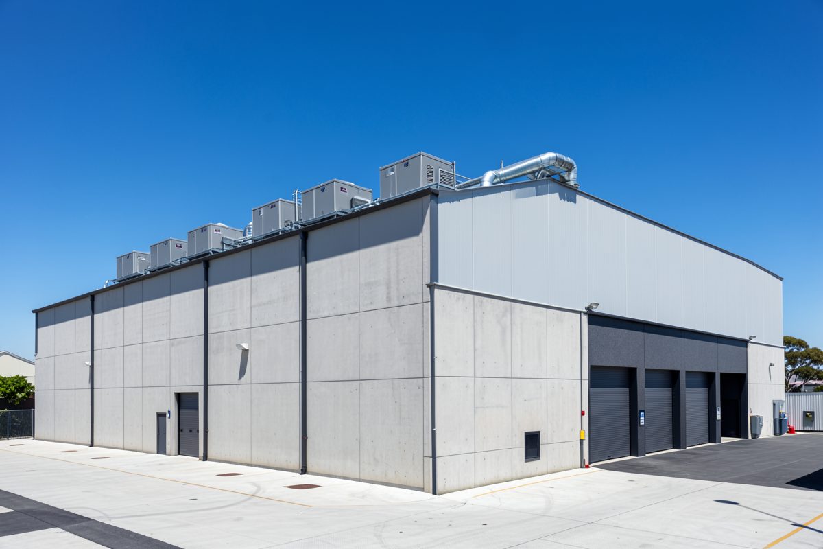 Large modern industrial warehouse in Melbourne with packaged HVAC rooftop units
